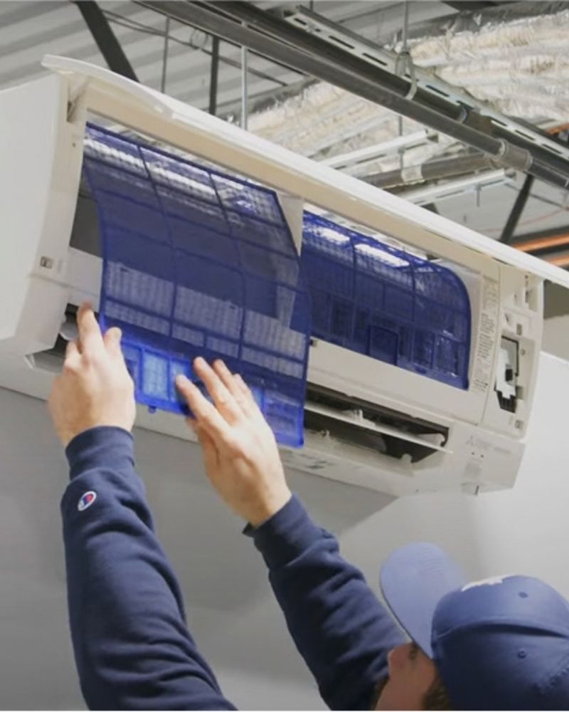 HVAC technician servicing an outdoor condenser unit
